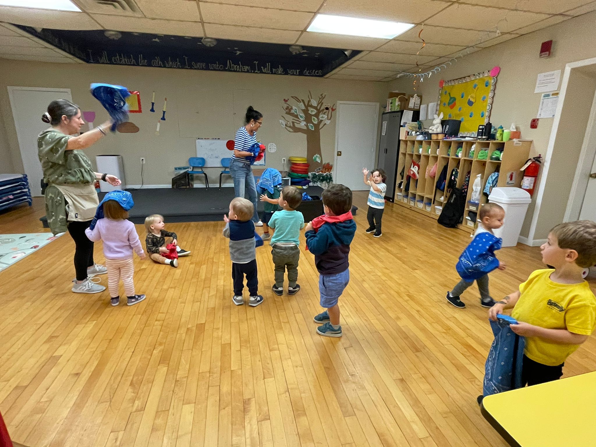 Shalom Yeladim children with their teachers playing in a classroom.