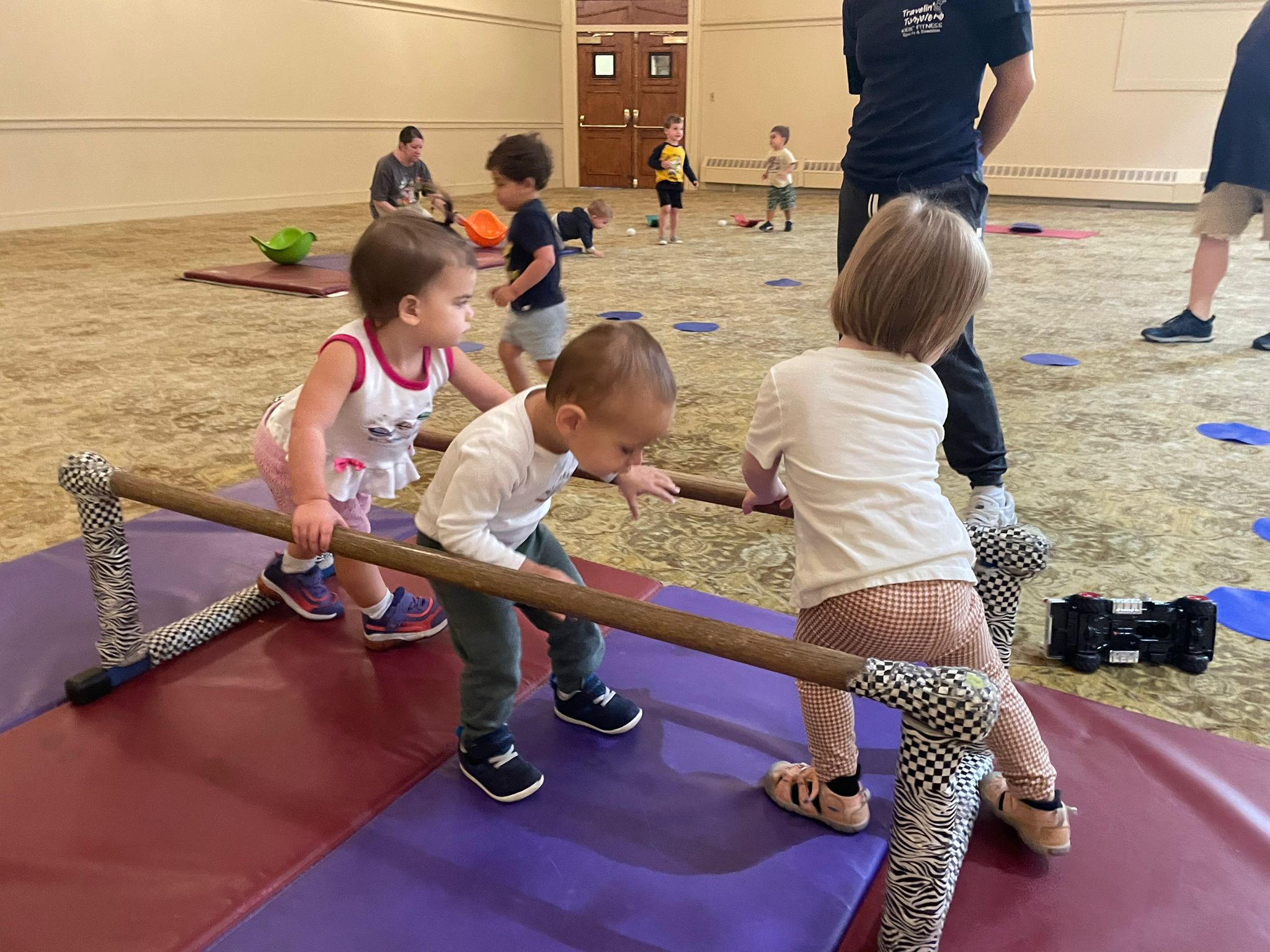 Shalom Yeladim children with their teachers playing in the ballroom.