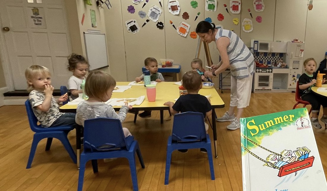 Shalom Yeladim children with teacher having a snack.