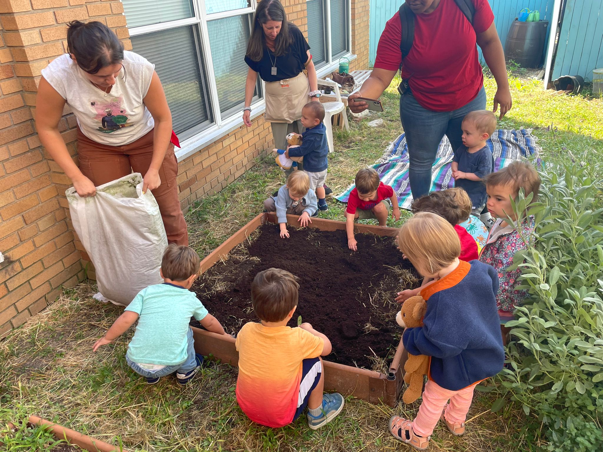 Shalom Yeladim children planting their garden.