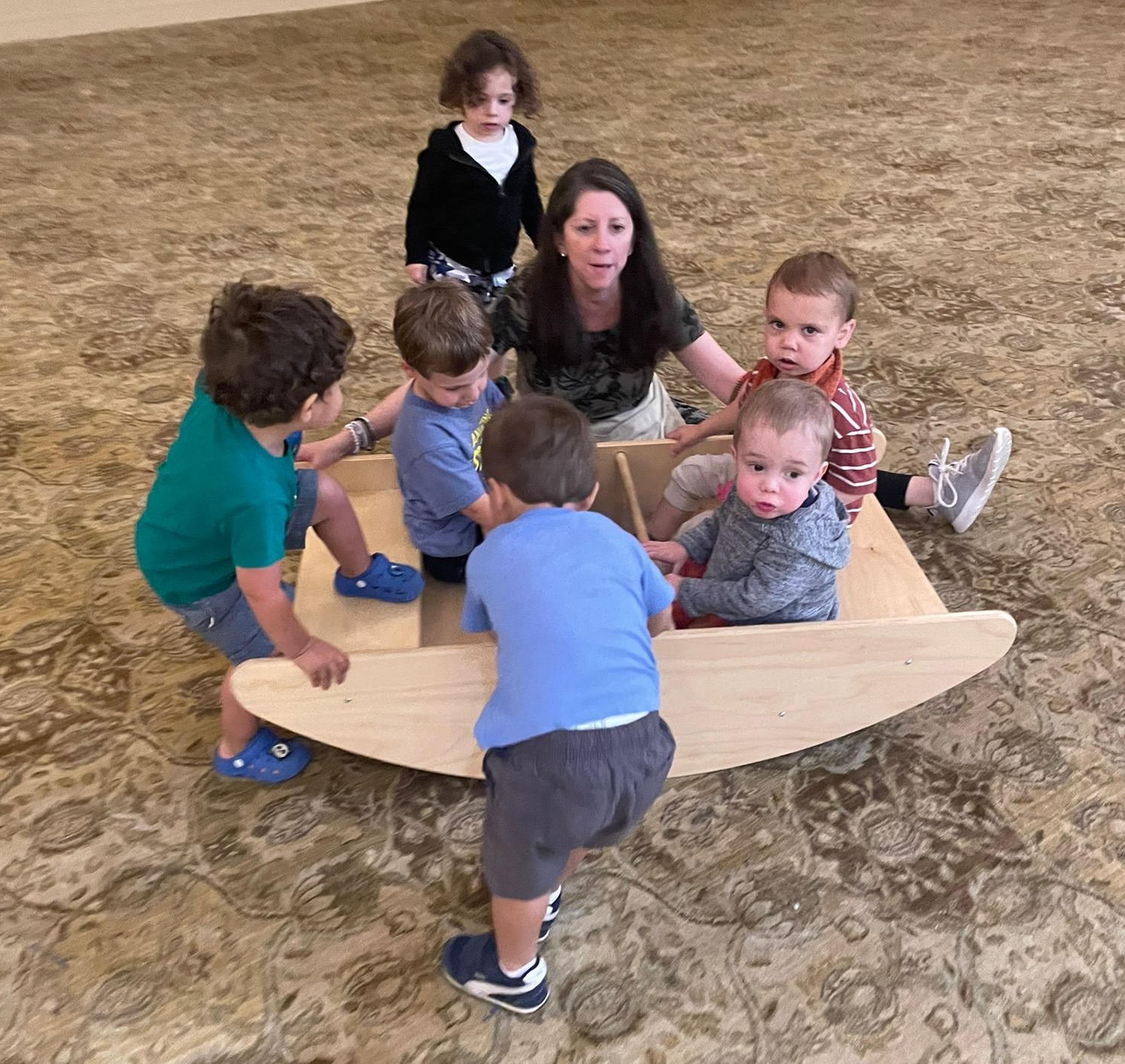 Shalom Yeladim children with their teachers playing in the ballroom.